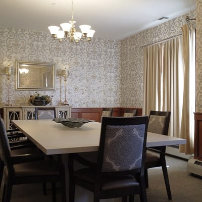 A well-decorated dining room with large table and chairs