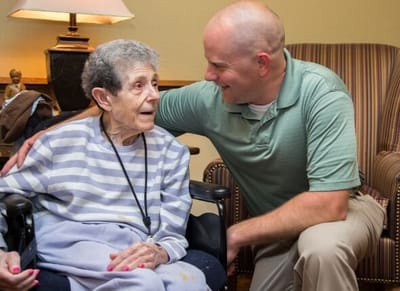 Staff member interacting with a resident in a shared space