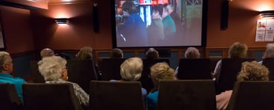 Residents watching a movie in a communal space
