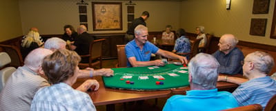 Residents enjoying a card game in a common area
