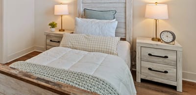 Cozy bedroom interior with two lamps and a clock