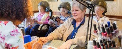 Residents enjoying a manicure in a communal salon