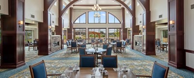 Dining room with tables and chairs set for meals