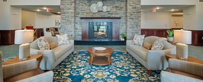 Cozy lounge area with seating and a fireplace