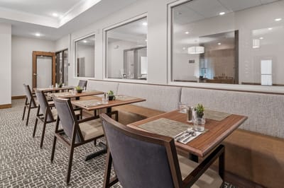 Dining area with neatly set tables and plants