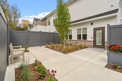 Outdoor patio area with benches and landscaping