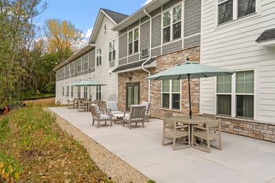 Outdoor patio with chairs and tables for residents