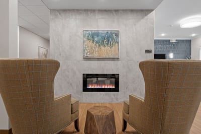 Cozy common area with comfortable chairs and fireplace