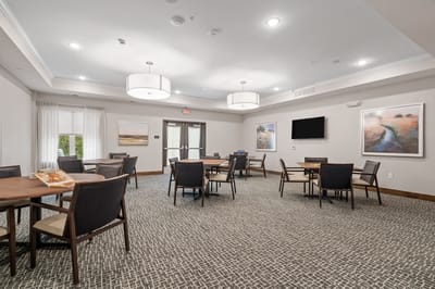 Bright common area with tables and artwork