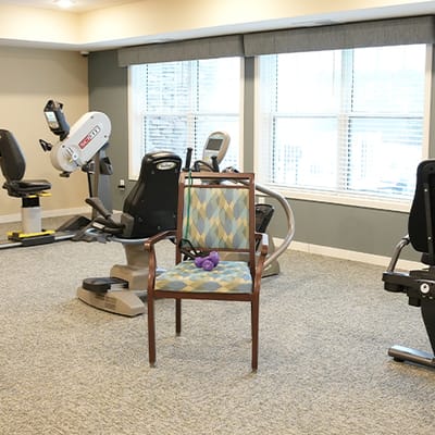 Interior fitness area with exercise equipment and a chair