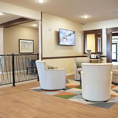 Common area with seating and decor in a senior living facility