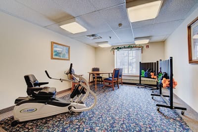 A well-equipped fitness room with exercise equipment