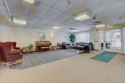 Interior view of a common area with seating and a piano