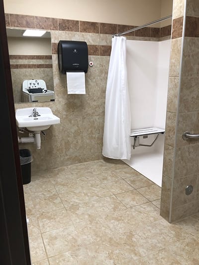 Clean, accessible bathroom with grab bars and shower