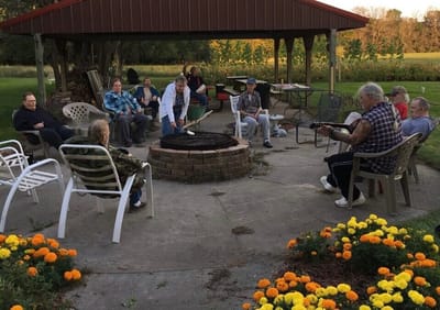 Residents enjoying an outdoor gathering around a fire pit