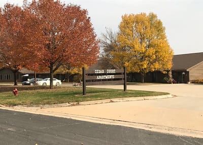 Exterior view of Cedar Court Apartments with colorful trees
