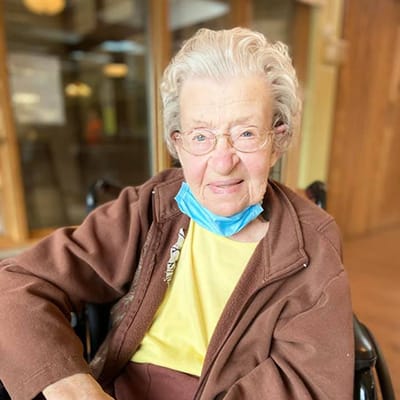 Elderly resident smiling in a common area