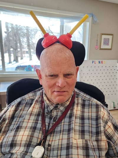 Resident wearing a playful headband during an activity