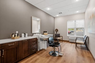 Interior of a hair salon with styling chairs and mirror