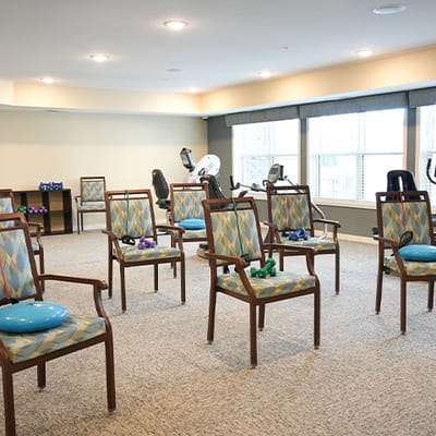Activity room with chairs and weights set up for exercise