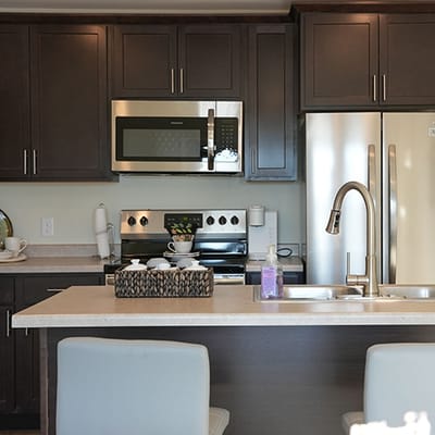 Modern kitchen with dark cabinets and appliances