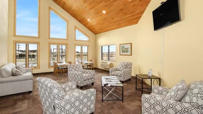 Bright common area with couches and dining tables