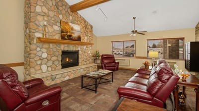 Cozy common area with leather seating and a fireplace