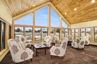 Bright common area with comfortable seating and large windows