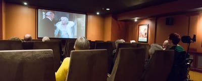 Residents watching a movie in a cozy theater