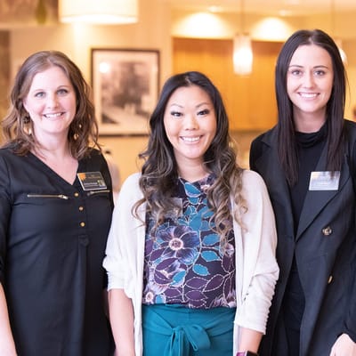 Staff members posing together in a bright common area