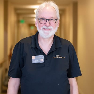 Staff member smiling in a hallway