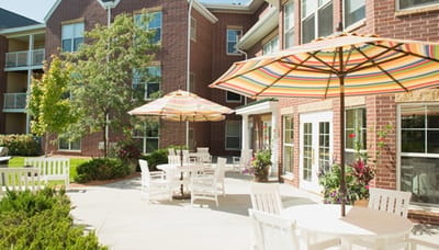 Outdoor patio area with colorful umbrellas and seating