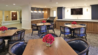 Bright common area with tables and flowers