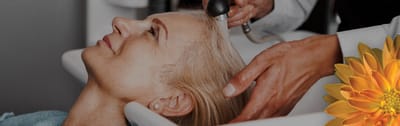 Resident receiving a hair treatment in a salon