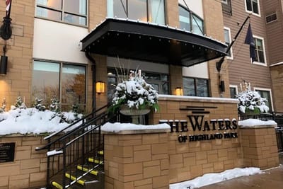Front entrance of The Waters of Highland Park with decorative planters