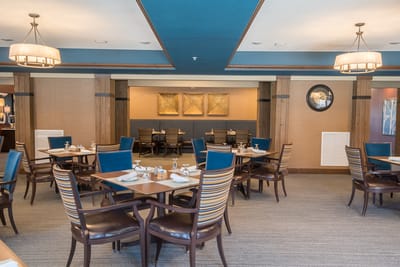 Interior view of a dining room with tables and chairs