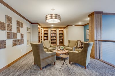 Cozy reading nook with armchairs and bookshelves