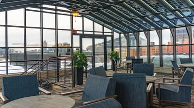 Bright common area with large windows and seating