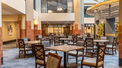 Bright lobby area with tables and chairs