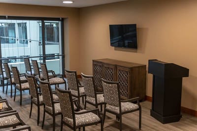 A well-lit interior meeting room with seating