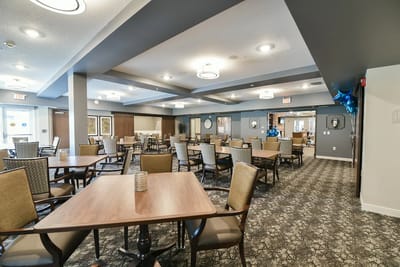 Dining area with tables and chairs set for residents