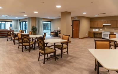 Bright common area with seating and kitchen appliances