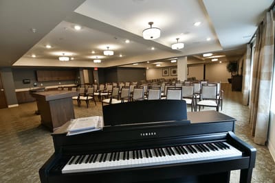 Interior view of a common area with seating and a piano