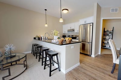 Modern kitchen area with seating and appliances