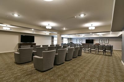 Bright, spacious common area with chairs and screens