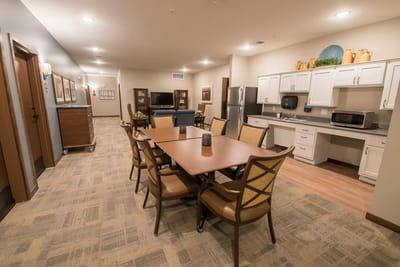 Common area with dining table and kitchenette
