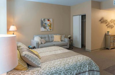 Cozy private resident room with a bed and sofa