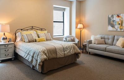 Cozy senior living room with a bed and sofa