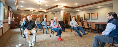 Residents attending a group session in the activity room