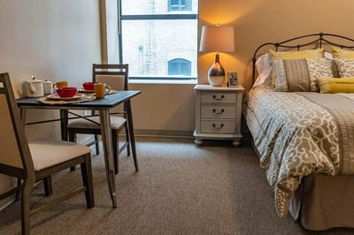 Cozy resident room with dining area and bed